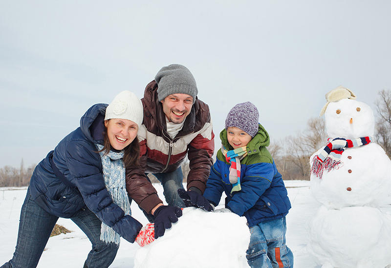 Зимние каникулы родители. Семья зимой. Зимние развлечения для детей и родителей. Семья лепит снеговика. Семья на улице зимой.