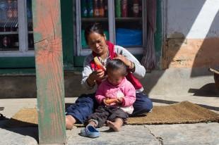 Mother fixing daughter's hair on Annapurna Base Camp trek, Nepal